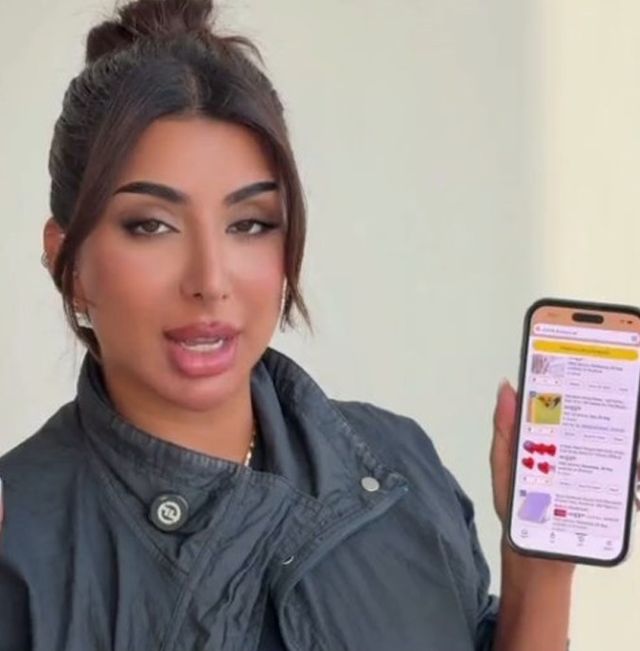 Creator holding a phone showing the Amazon app