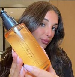 Creator holding a Schwarzkopf Professional product